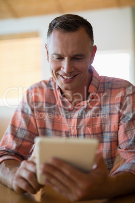Man using digital tablet in restaurant