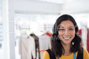 Smiling fashion designer in office