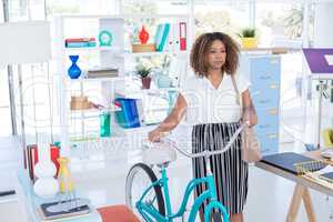 Female executive walking with bicycle