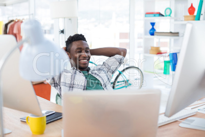 Male executive relaxing at his desk