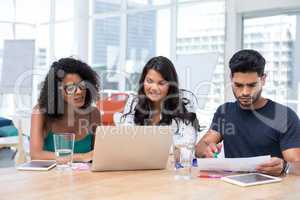 Executives working on laptop in the office