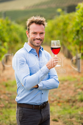 Portrait of smiling man holding red wineglass