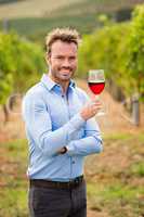 Portrait of smiling man holding red wineglass
