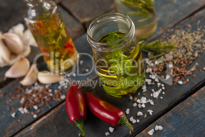 Herbs with oil  in container amidst spices