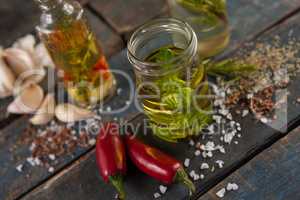 Herbs with oil  in container amidst spices