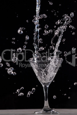 Vodka splashing in martini glass