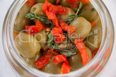 Overhead view of green olives with chili pepper