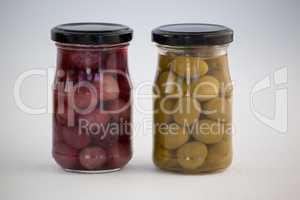 Close up of green and brown olives in jar