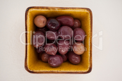 Brown olives in yellow bowl