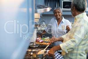 Smiling woman coffee cup talking with man preparing food