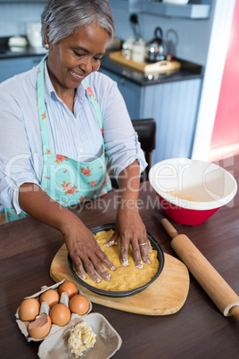High angle view of smiling woman preparing food