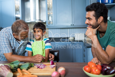 Man looking at happy boy and grandfather