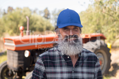 Portrait of happy man standing in olive farm