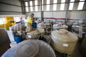 Worker removing oil from tank