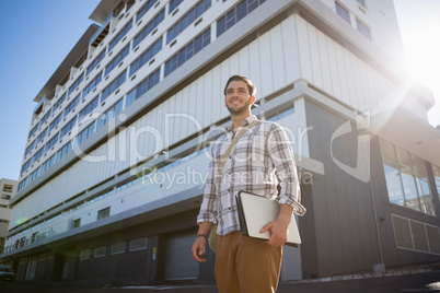 Smiling thoughtful man looking away in city