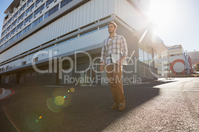 Man looking away while standing on city street