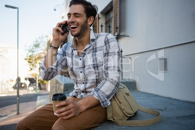 Cheerful man talking on mobile phone