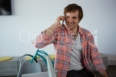 Smiling businessman talking on phone