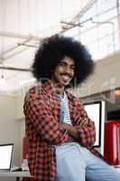 Portrait of confident man at desk in office