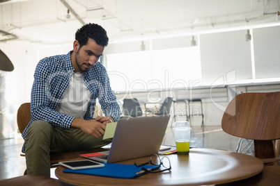 Man looking at laptop in office