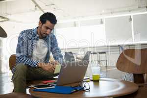 Man looking at laptop in office