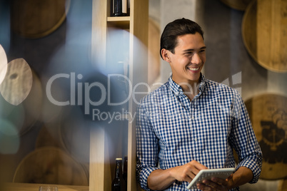 Bar tender using digital tablet at counter