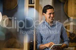 Bar tender using digital tablet at counter