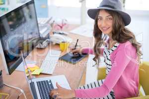 Female graphic designer working at desk in the office