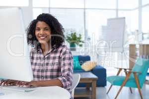 Female executive working on computer at desk