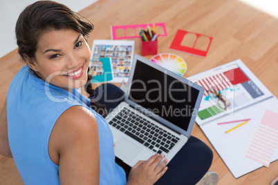 Graphic designer using laptop in the office