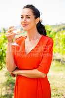 Smiling woman looking away while having wine
