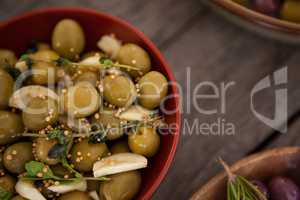 Close up of green olives with spice served in bowl