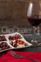 Black olives served in plate by wine on table