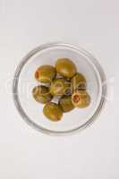 Overhead view of olives in glass bowl