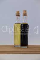 Olive oil in bottles on wooden table