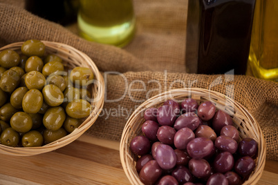 High angle view of green and brown olives in wicker basket