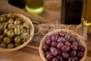 High angle view of green and brown olives in wicker basket