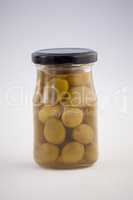 Close up of green olives in jar