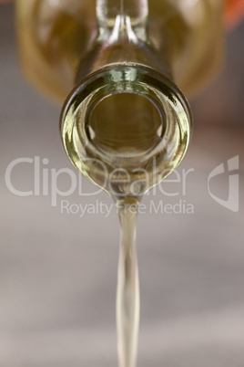 Close up of bottle pouring olive oil