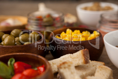 Olives and corns in bowls by ingredients