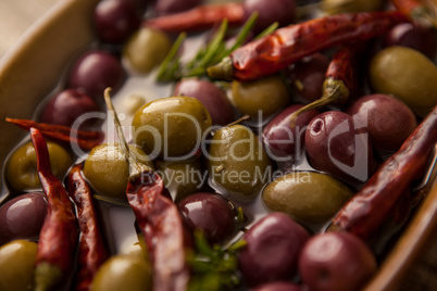 Tilt image of olives with red chili pepper