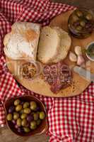 Bread and olives with meat on napkin