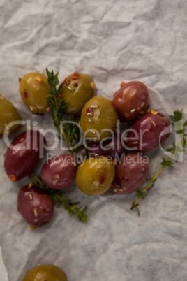 Olives with thyme on wax paper