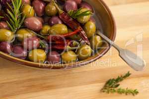 High angle view of olives with red chili pepper and herb