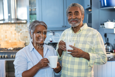 Portrait of smiling senior couple with coffee cups