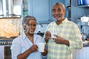 Portrait of smiling senior couple with coffee cups