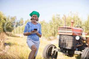 Portrait of happy woman using mobile phone in olive farm