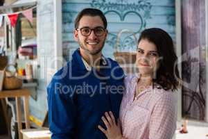 Smiling couple standing at restaurant