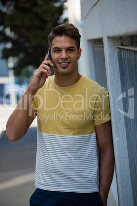 Portrait of smiling young man talking on mobile phone
