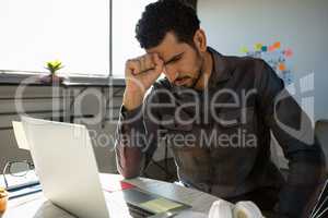 Frustrated businessman sitting at desk